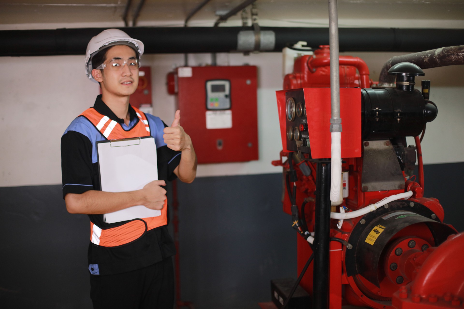 Safety engineers inspect the piping system and operation of fire hydrants in the factory.  Safety Technician inspects fire hydrant system under building construction